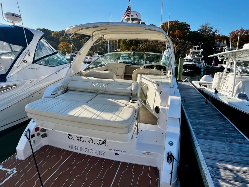Slide: The Image of 2018 Regal 33 Express boat docked, featuring spacious seating and sleek design. - 13