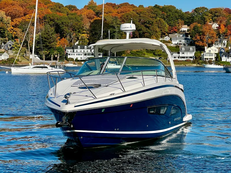 Slide: The Image of 2018 Regal 33 Express boat with beige seating at a marina dock. - 18