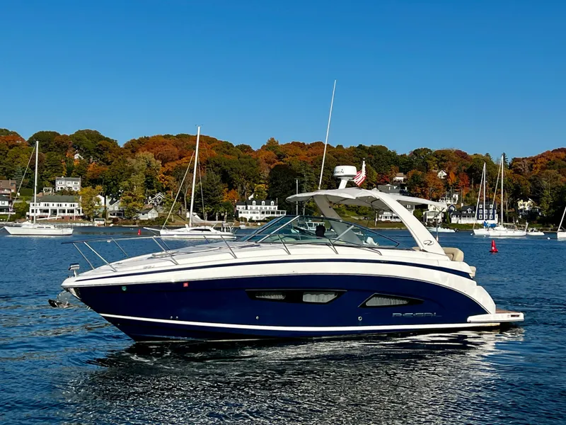 Slide: The Image of 2018 Regal 33 Express boat on a scenic lake with autumn trees. - 2