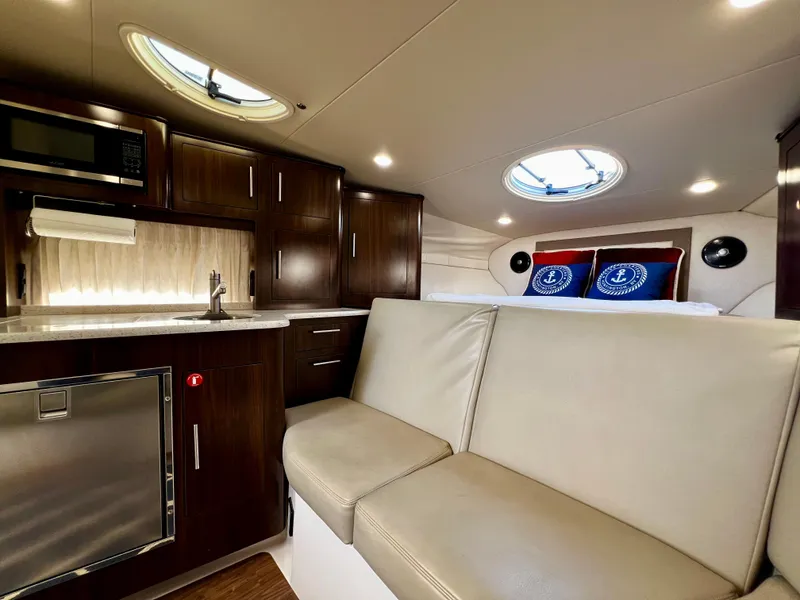 Slide: The Image of Luxurious interior of 2018 Regal 33 Express yacht with modern kitchen and seating area. - 35