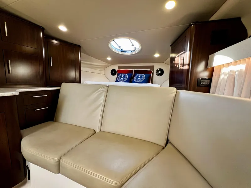 Slide: The Image of Luxurious interior of 2018 Regal 33 Express yacht with beige seating and modern cabinetry. - 36