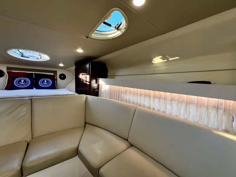Slide: The Image of Luxurious interior of 2018 Regal 33 Express yacht with beige seating and porthole windows. - 38