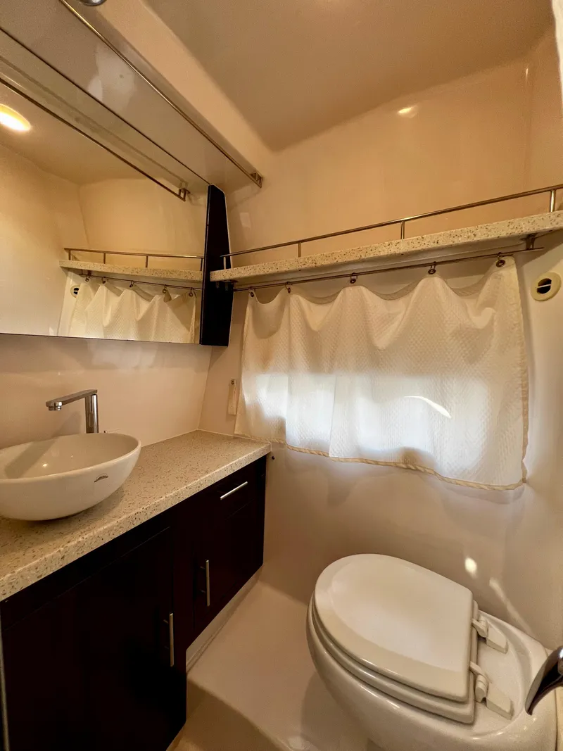 Slide: The Image of 2018 Regal 33 Express bathroom with modern sink, toilet, and mirror. - 42