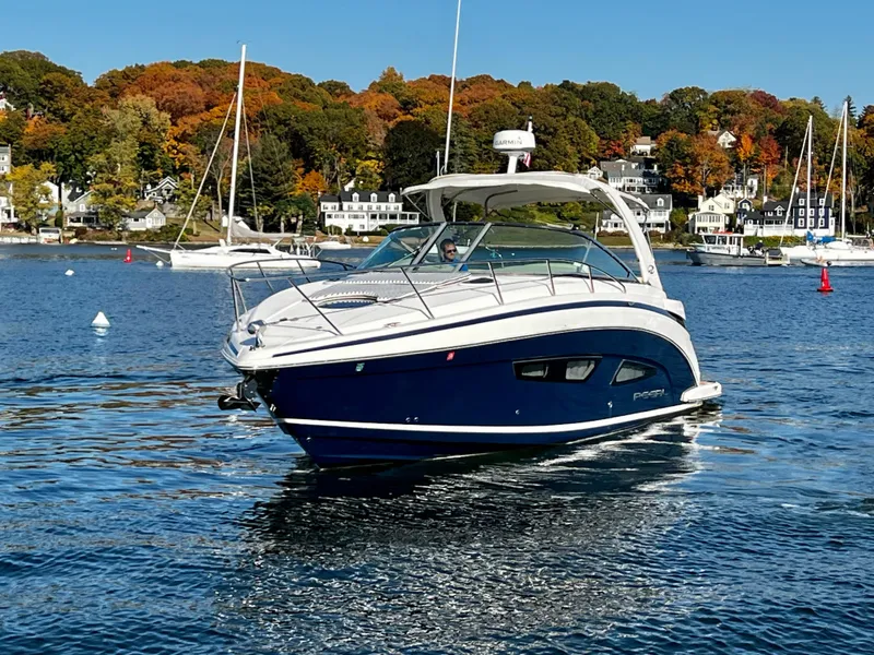 Slide: The Image of 2018 Regal 33 Express boat cruising on a scenic lake with autumn foliage. - 47