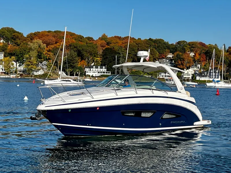 Slide: The Image of 2018 Regal 33 Express boat on a scenic lake with autumn foliage. - 48