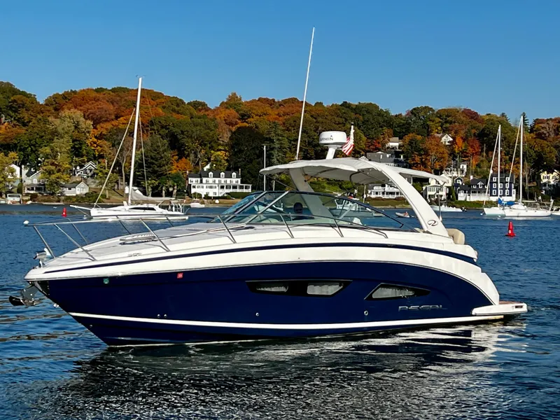 Slide: The Image of 2018 Regal 33 Express boat on a scenic lake with autumn foliage. - 49