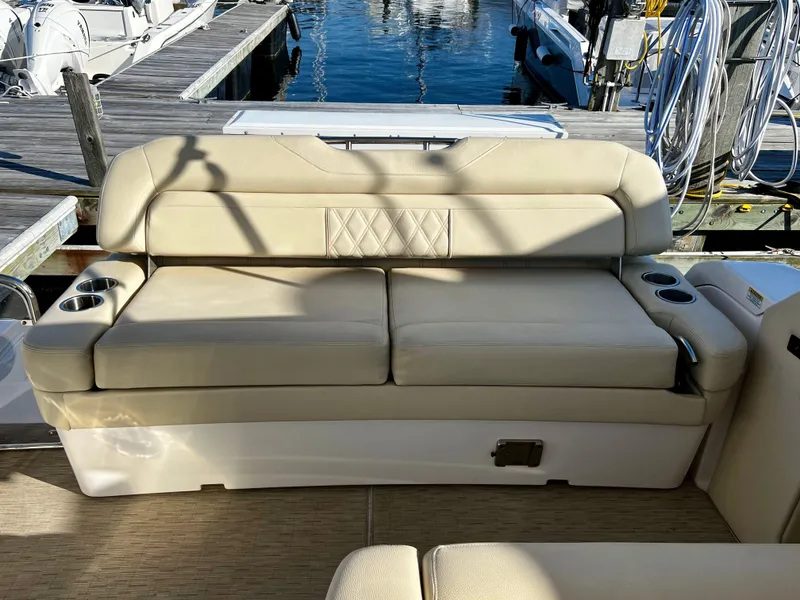 Slide: The Image of Luxurious seating on a 2018 Regal 33 Express boat at a marina. - 5