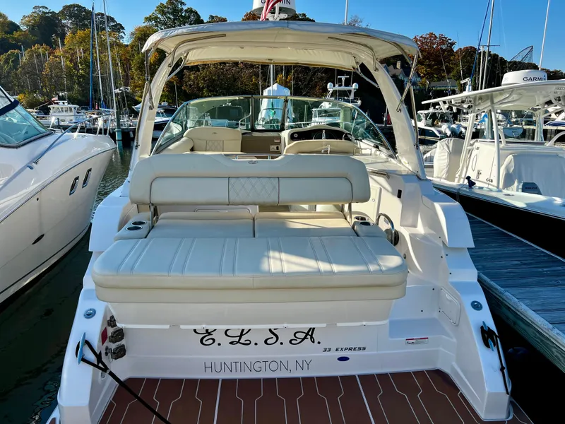 Slide: The Image of Cozy cabin interior of 2018 Regal 33 Express with striped bedding and pillows. - 7