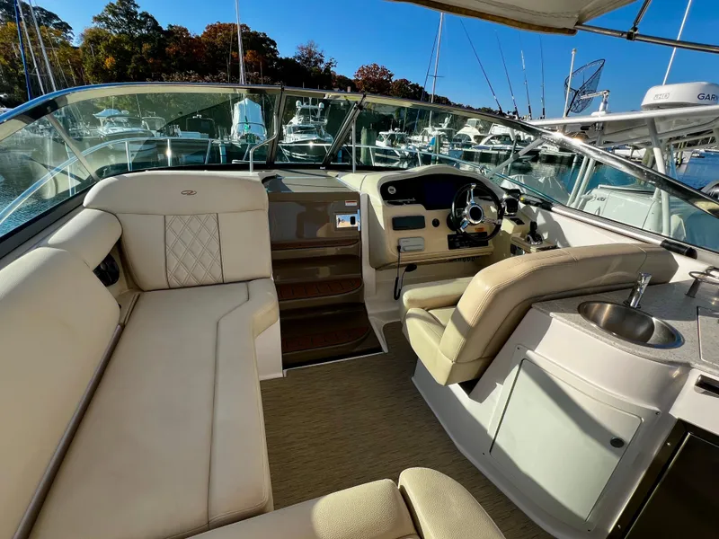 Slide: The Image of 2018 Regal 33 Express cabin interior with striped bedding and wooden steps. - 9