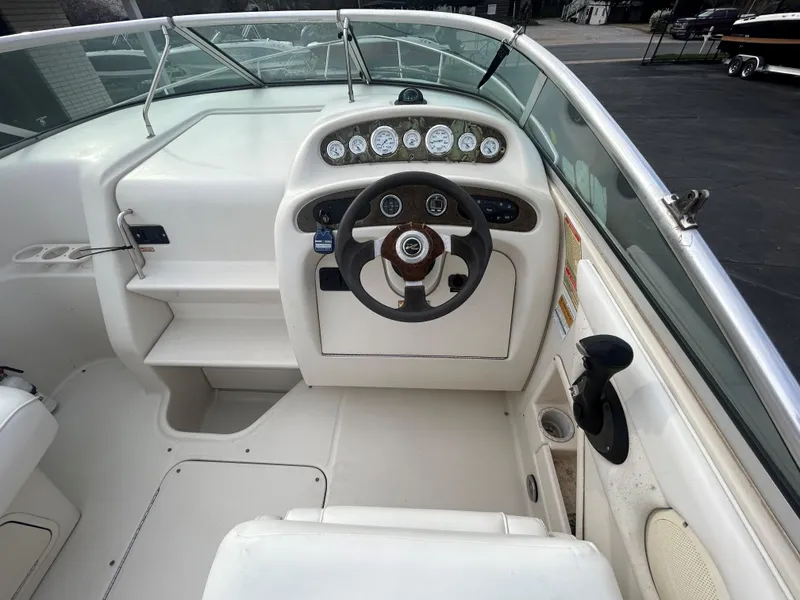 Slide: The Image of 2001 Sea Ray 245 Weekender boat cockpit with steering wheel and instrument panel. - 5