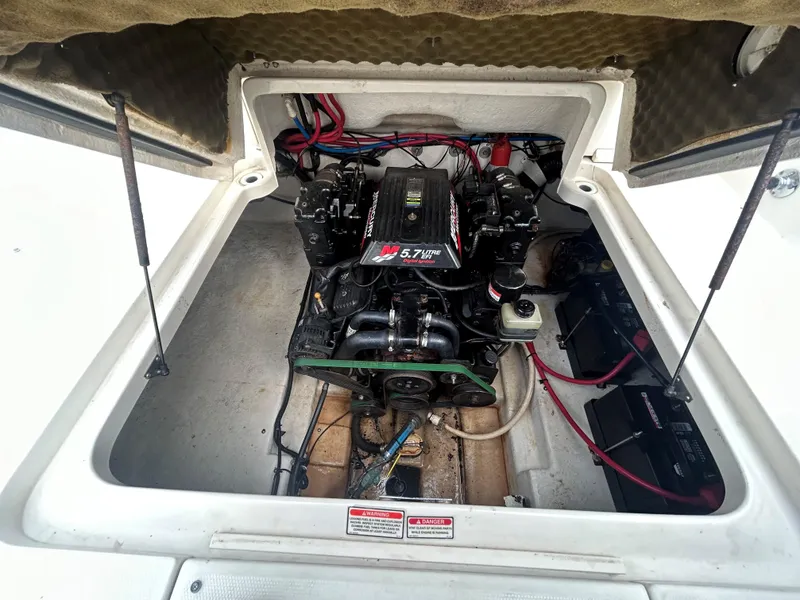Slide: The Image of Engine compartment of a 2001 Sea Ray 245 Weekender boat, featuring a 5.7L engine. - 7