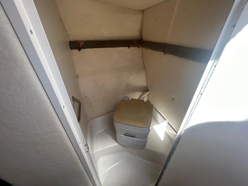 Slide: The Image of 2001 Sea Ray 245 Weekender boat interior with compact toilet. - 8