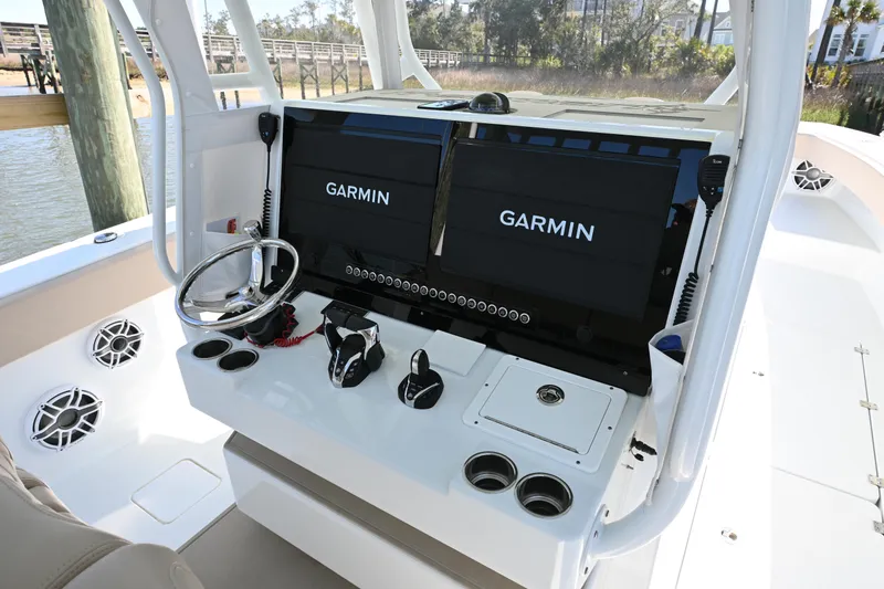 Slide: The Image of 2024 Freeman 37 VH boat dashboard with dual Garmin displays and steering wheel. - 12