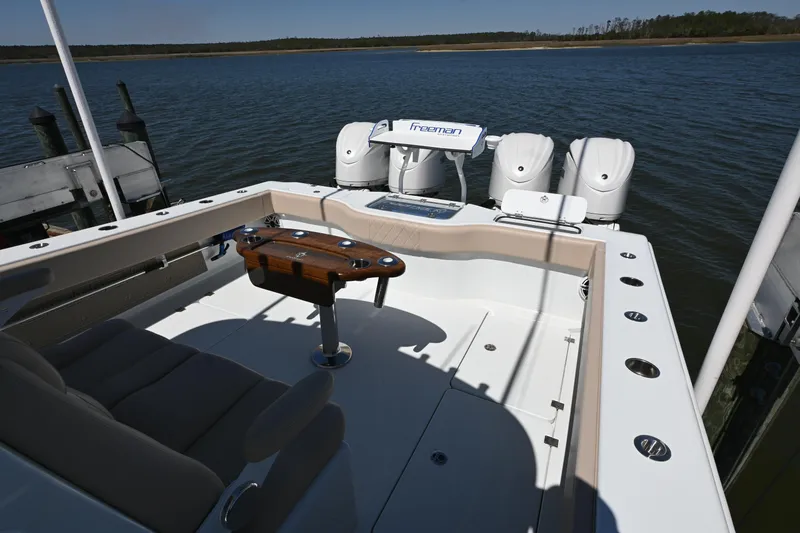 Slide: The Image of 2024 Freeman 37 VH boat with triple engines docked on calm water. - 15