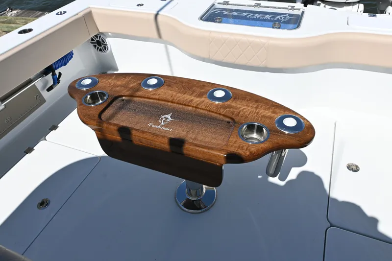 Slide: The Image of 2024 Freeman 37 VH boat with a wooden fishing rod holder on deck. - 17