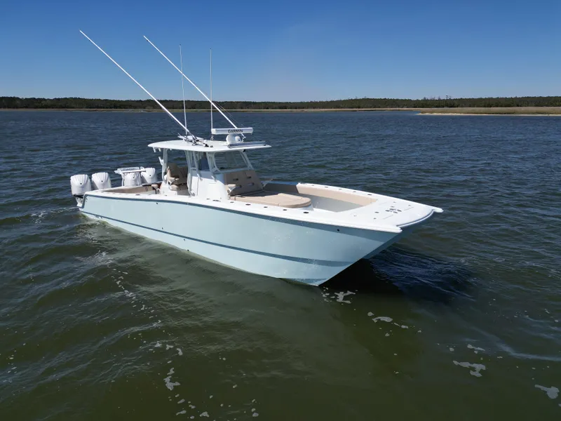 Slide: The Image of 2024 Freeman 37 VH boat cruising on open water under clear blue sky. - 4