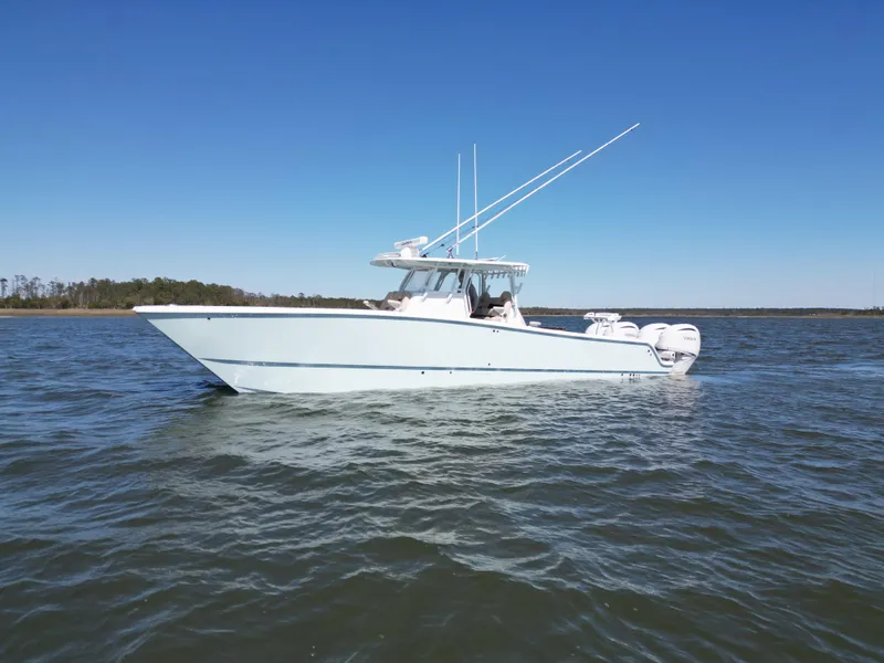 Slide: The Image of 2024 Freeman 37 VH boat on calm water under clear blue sky. - 5