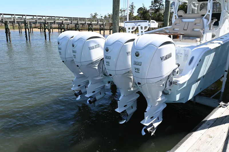 Slide: The Image of Four Yamaha outboard motors on a 2024 Freeman 37 VH boat docked by the water. - 6