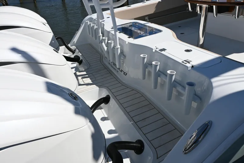 Slide: The Image of 2024 Freeman 37 VH boat deck with multiple rod holders and powerful engines. - 7