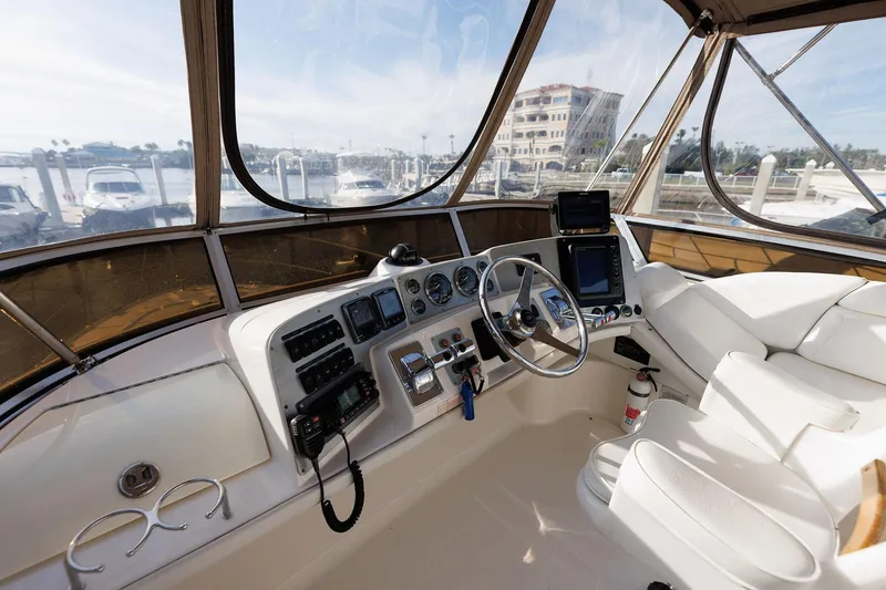 Slide: The Image of 2003 Regal Commodore 3880 yacht cockpit with steering wheel and control panel. - 11