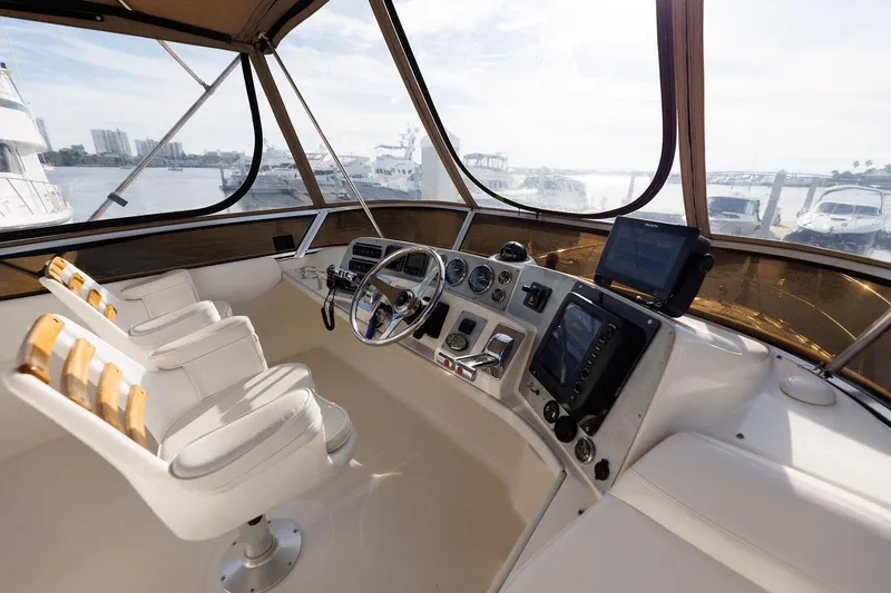 Slide: The Image of 2003 Regal Commodore 3880 yacht helm with modern controls and panoramic view. - 12