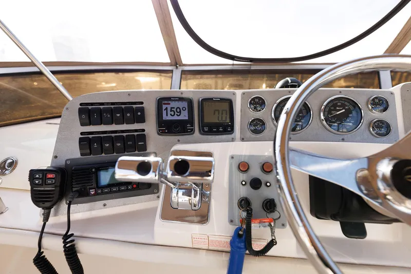 Slide: The Image of 2003 Regal Commodore 3880 helm with gauges, controls, and communication equipment. - 14