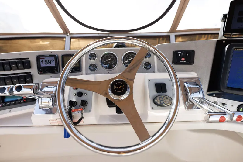 Slide: The Image of Steering wheel and dashboard of 2003 Regal Commodore 3880 boat. - 15