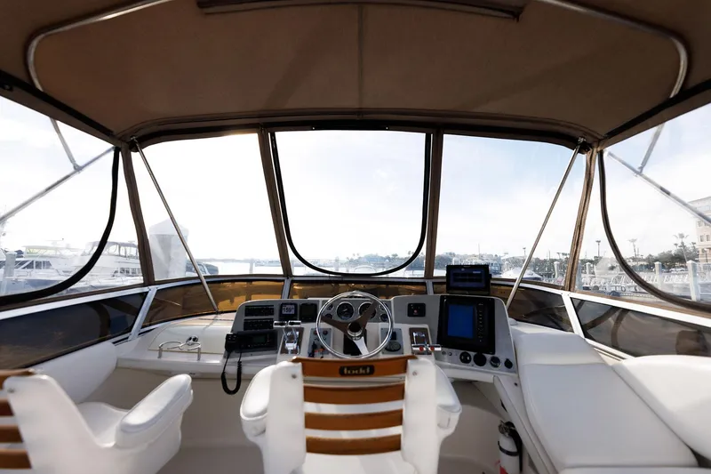 Slide: The Image of 2003 Regal Commodore 3880 yacht cockpit with steering wheel and navigation equipment. - 19