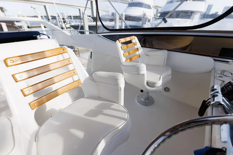 Slide: The Image of 2003 Regal Commodore 3880 yacht cockpit with white and wood-accented seating. - 20