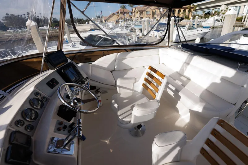 Slide: The Image of 2003 Regal Commodore 3880 yacht cockpit with white seating and steering wheel. - 22