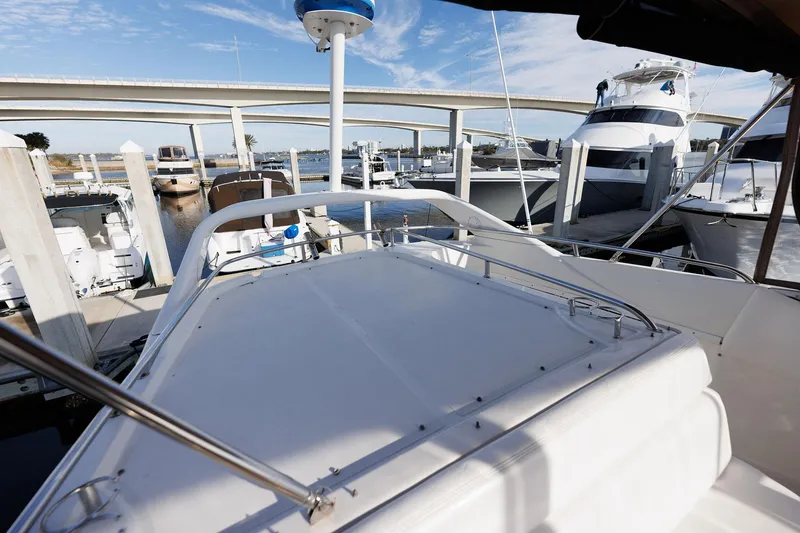 Slide: The Image of 2003 Regal Commodore 3880 yacht docked at marina under clear blue sky. - 24