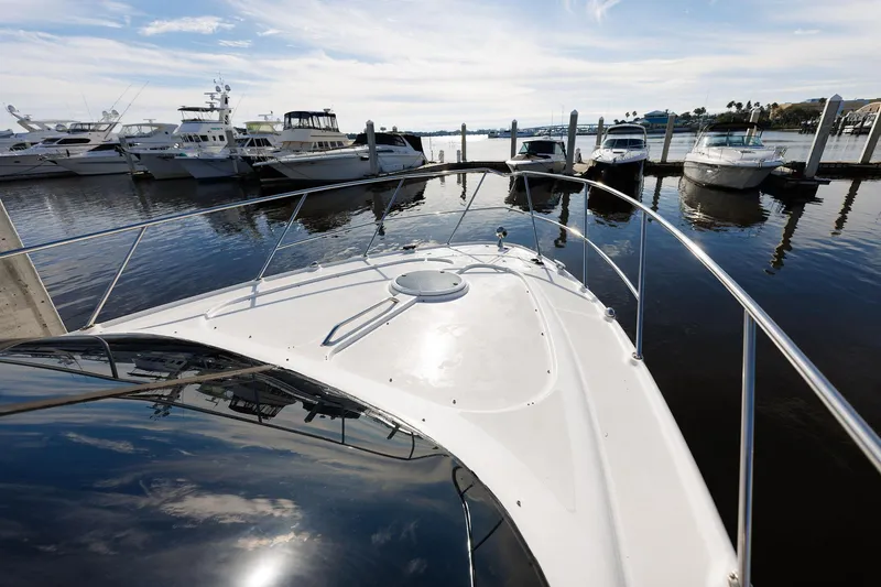 Slide: The Image of 2003 Regal Commodore 3880 yacht docked at marina, surrounded by other boats. - 27