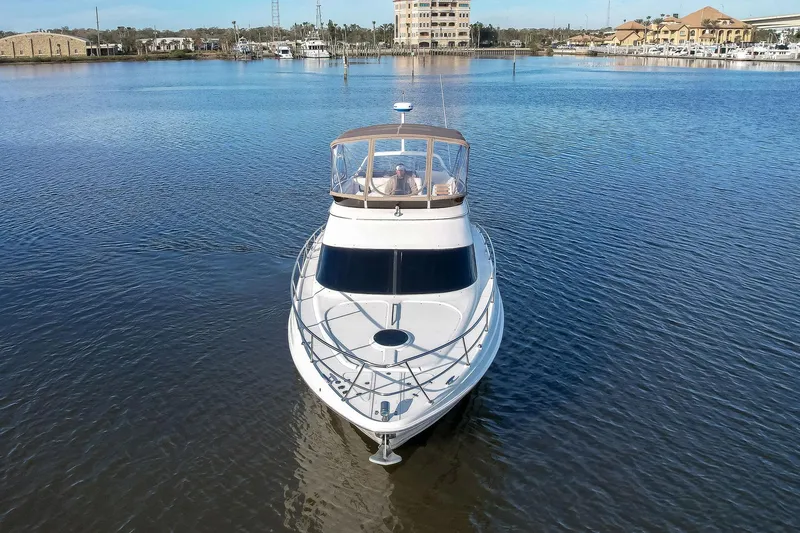Slide: The Image of 2003 Regal Commodore 3880 yacht on calm water, front view. - 3