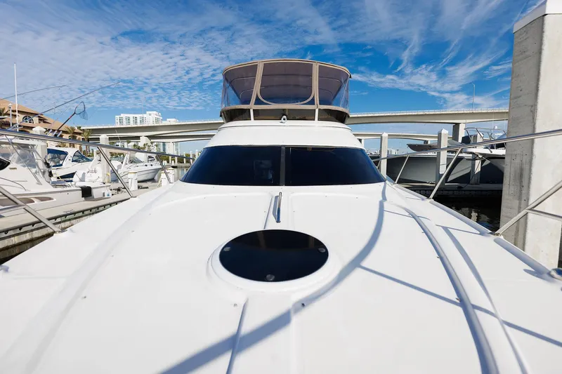 Slide: The Image of 2003 Regal Commodore 3880 yacht docked under a clear blue sky. - 30