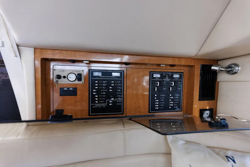 Slide: The Image of Control panel of 2003 Regal Commodore 3880 yacht with wood finish and various switches. - 47