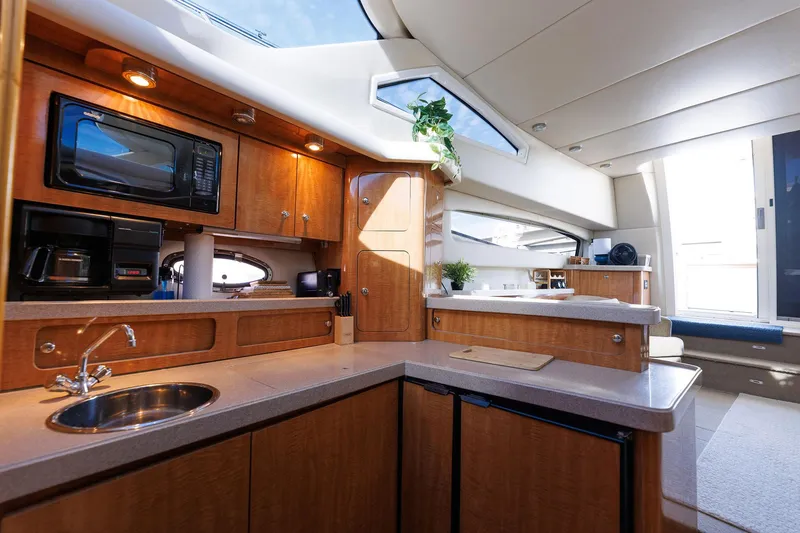 Slide: The Image of Luxurious interior of 2003 Regal Commodore 3880 yacht with modern kitchen amenities. - 49