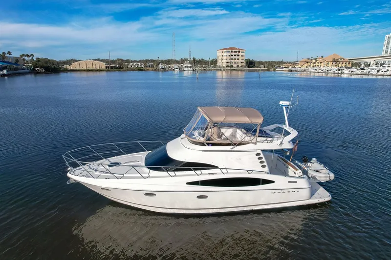 Slide: The Image of 2003 Regal Commodore 3880 yacht on calm water, clear sky background. - 6
