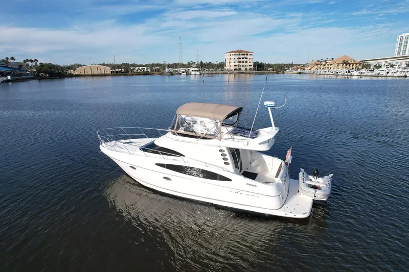 Slide: The Image of 2003 Regal Commodore 3880 yacht on calm water, under a clear blue sky. - 7