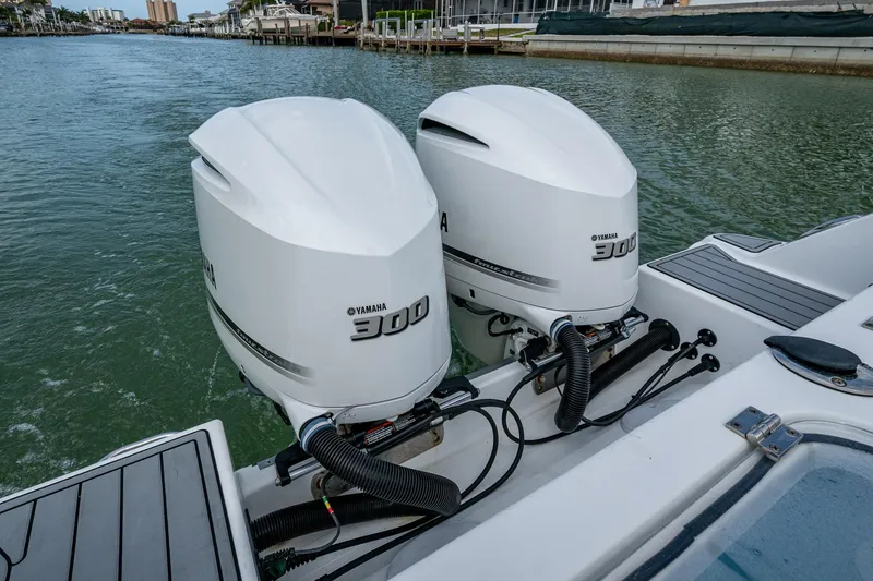 Slide: The Image of Twin Yamaha 300 engines on a 2020 Wellcraft 302 Fisherman boat in a marina. - 13