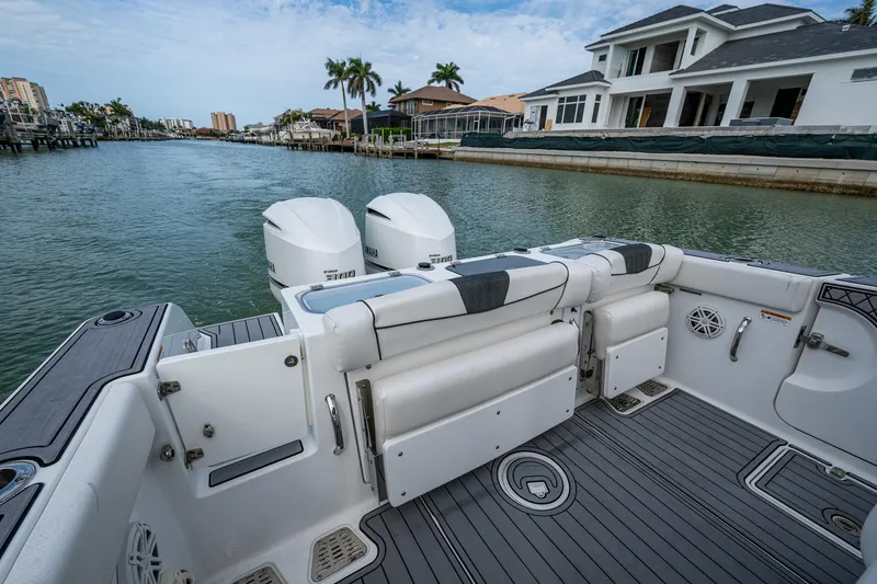 Slide: The Image of 2020 Wellcraft 302 Fisherman boat with dual engines docked by waterfront homes. - 14