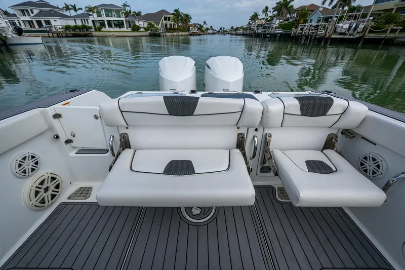 Slide: The Image of 2020 Wellcraft 302 Fisherman boat interior with cushioned seating and scenic waterfront view. - 16