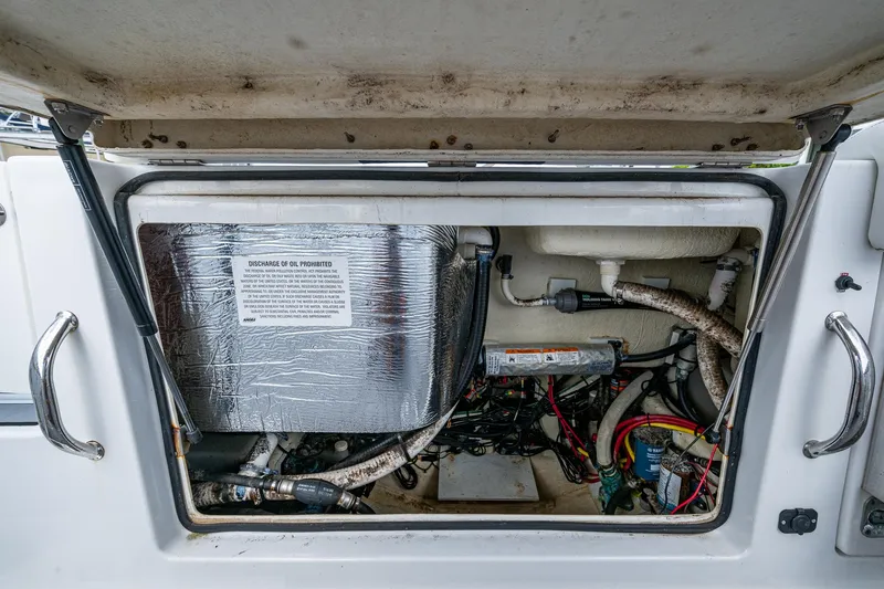 Slide: The Image of 2020 Wellcraft 302 Fisherman engine compartment with wiring and components visible. - 18