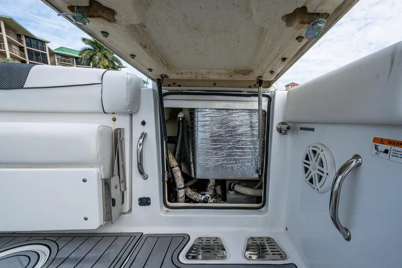 Slide: The Image of 2020 Wellcraft 302 Fisherman boat interior, open hatch revealing storage compartment. - 19