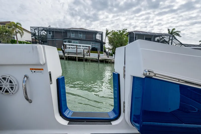 Slide: The Image of 2020 Wellcraft 302 Fisherman boat with open transom door, dockside view. - 20