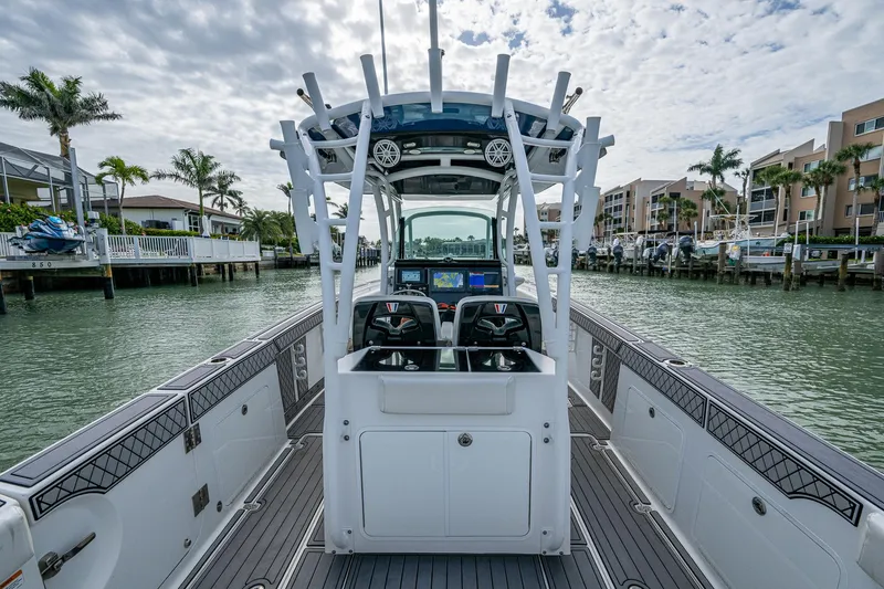 Slide: The Image of 2020 Wellcraft 302 Fisherman boat with dual consoles, docked in a marina. - 21