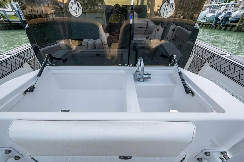 Slide: The Image of 2020 Wellcraft 302 Fisherman boat with dual sinks and faucet, docked by the water. - 24