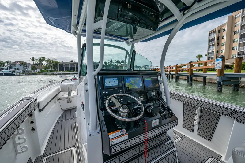 Slide: The Image of 2020 Wellcraft 302 Fisherman boat interior with modern navigation system and steering wheel. - 29