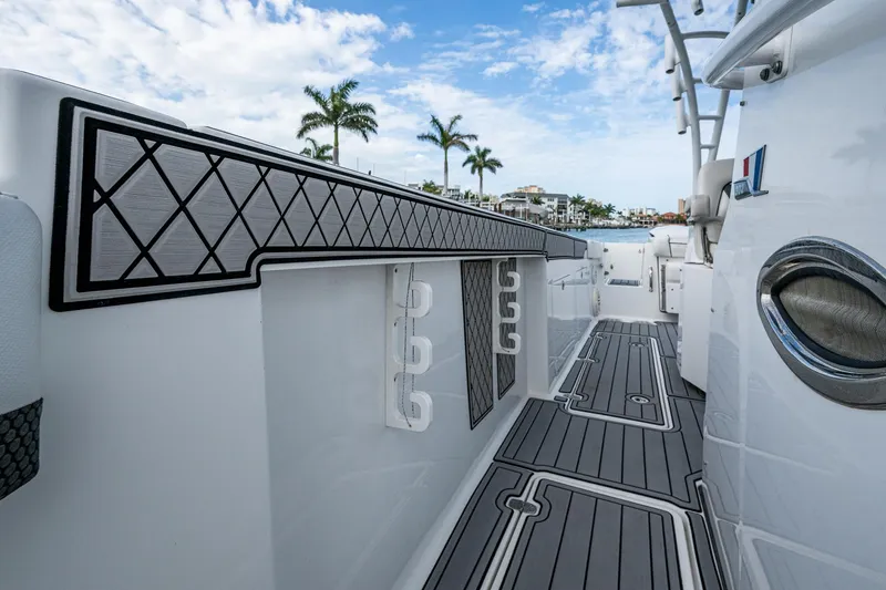 Slide: The Image of 2020 Wellcraft 302 Fisherman boat deck with sleek design and palm trees in the background. - 31