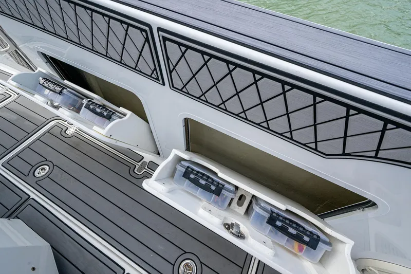 Slide: The Image of 2020 Wellcraft 302 Fisherman boat storage compartments with tackle boxes on deck. - 33