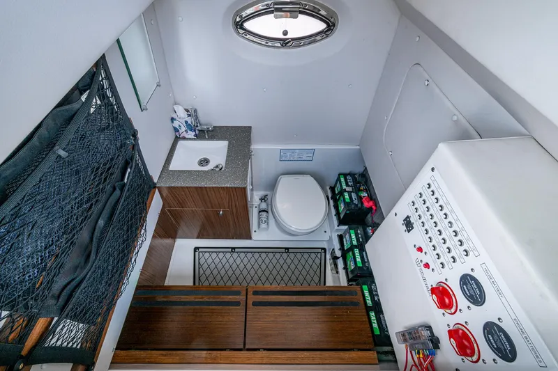 Slide: The Image of 2020 Wellcraft 302 Fisherman cabin interior with sink, toilet, and control panel. - 35